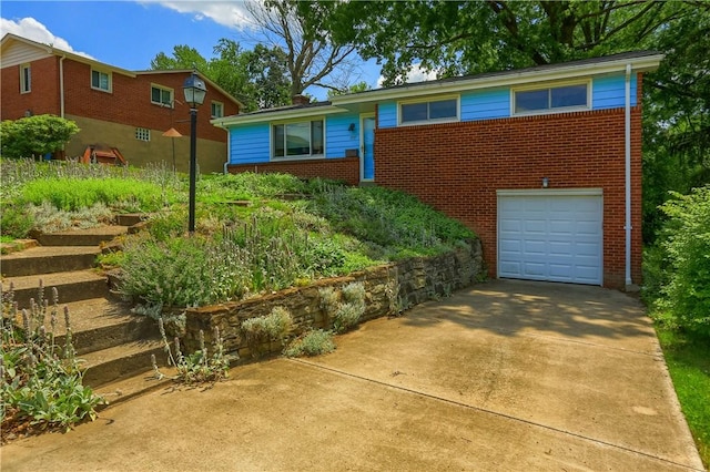 1117 Meadowlark Dr, Pittsburgh, PA 15243 - view of front of house with brick siding, an attached garage, and driveway