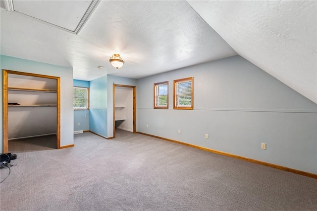 409 Park Rd, Bullskin Twp, PA 15683 - unfurnished bedroom featuring carpet floors, a textured ceiling, attic access, and vaulted ceiling