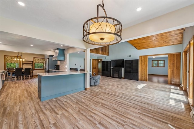 409 Park Rd, Bullskin Twp, PA 15683 - kitchen with light wood-type flooring, open floor plan, lofted ceiling, light countertops, and a chandelier
