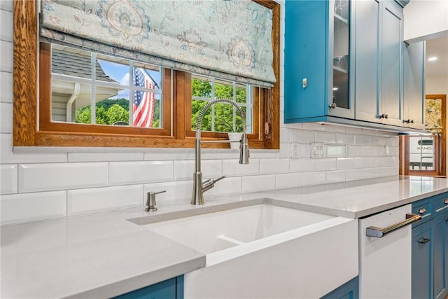 409 Park Rd, Bullskin Twp, PA 15683 - kitchen featuring blue cabinetry, light countertops, backsplash, and glass insert cabinets