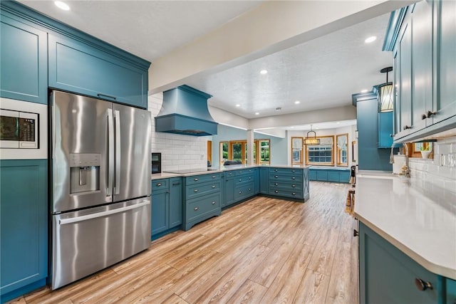 409 Park Rd, Bullskin Twp, PA 15683 - kitchen with appliances with stainless steel finishes, premium range hood, a peninsula, light wood-style floors, and backsplash