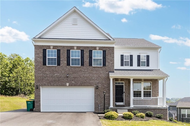 829 Frickwood Dr, South Park, PA 15129 - view of front facade with covered porch, brick siding, asphalt driveway, and a garage