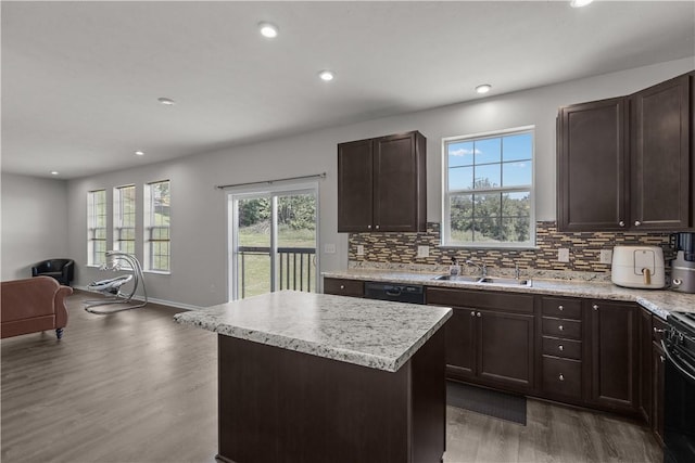 829 Frickwood Dr, South Park, PA 15129 - kitchen with open floor plan, light wood-style floors, dark brown cabinets, a kitchen island, and backsplash