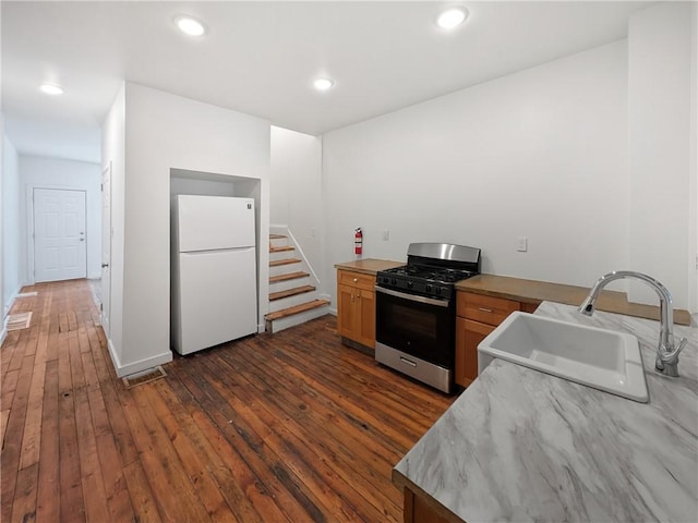 7304 Forest Way, Homewood-Brushton, PA 15208 - kitchen featuring freestanding refrigerator, gas range, dark wood-style floors, recessed lighting, and light countertops