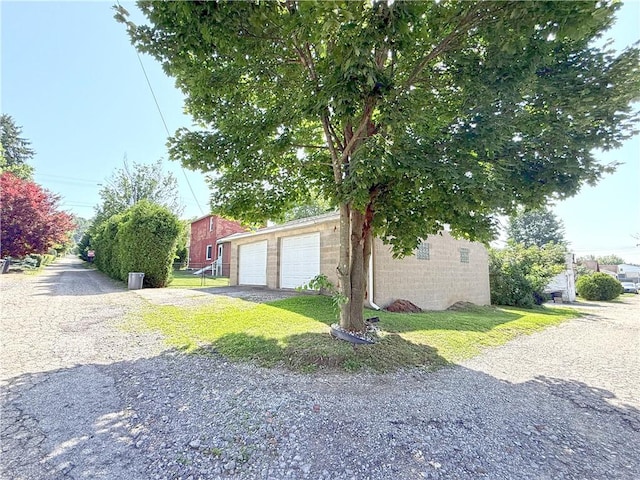 208 Beale Ave, Leechburg Boro, PA 15656 - view of side of home featuring a garage, an outdoor structure, and a yard