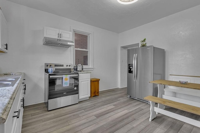 1104 Allegheny St, New Brighton, PA 15066 - kitchen featuring stainless steel appliances, under cabinet range hood, light wood-style floors, and white cabinetry