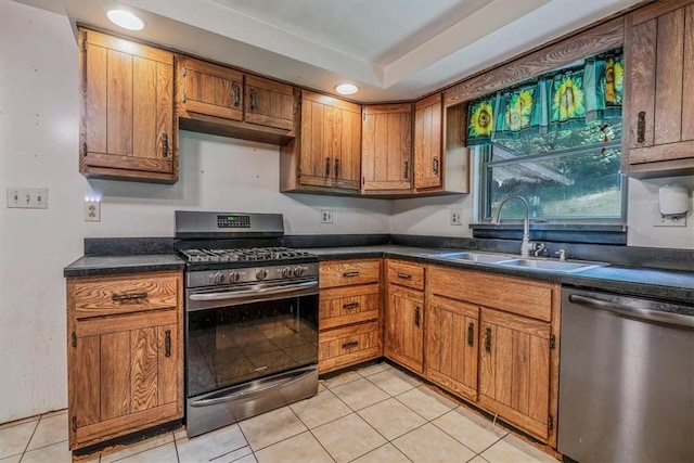 5028 W Smithfield St, Elizabeth Twp/Boro, PA 15135 - kitchen featuring appliances with stainless steel finishes, light tile patterned flooring, brown cabinetry, dark countertops, and recessed lighting
