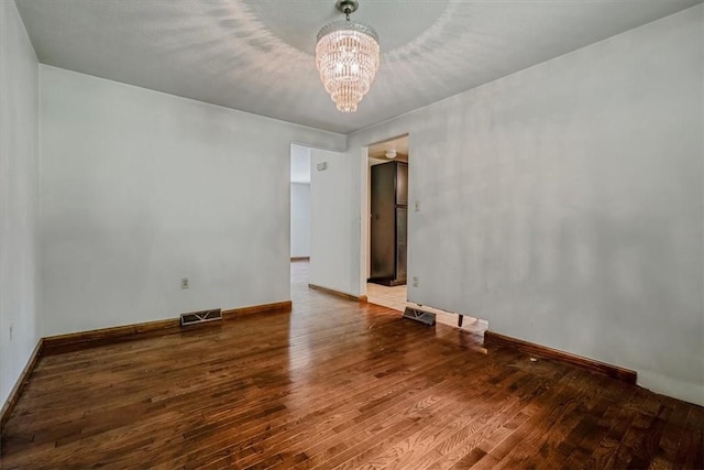 5028 W Smithfield St, Elizabeth Twp/Boro, PA 15135 - unfurnished room featuring a chandelier and wood finished floors