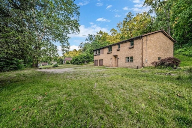 5028 W Smithfield St, Elizabeth Twp/Boro, PA 15135 - view of side of property featuring an attached garage and a lawn