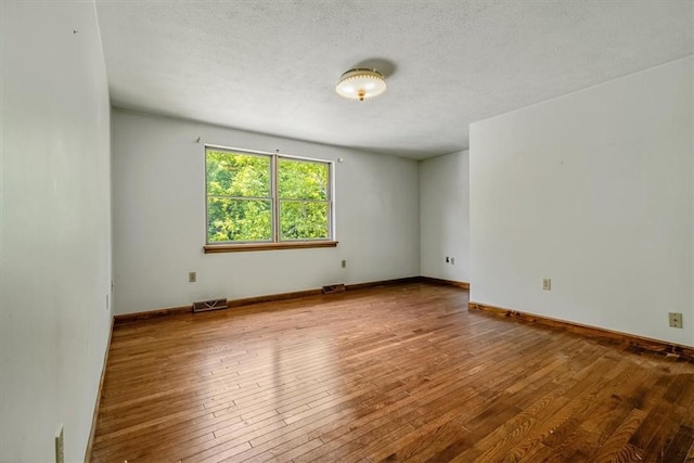 5028 W Smithfield St, Elizabeth Twp/Boro, PA 15135 - spare room featuring hardwood / wood-style floors and a textured ceiling