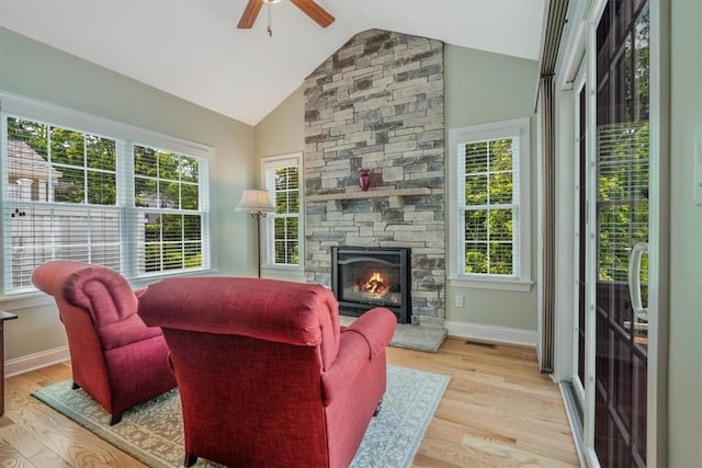 1303 Shinnecock Ct, Adams Twp, PA 16046 - living room featuring ceiling fan, vaulted ceiling, wood finished floors, and a stone fireplace