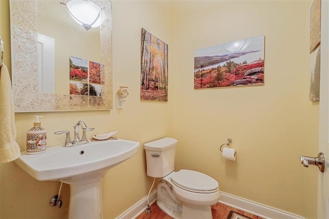 1303 Shinnecock Ct, Adams Twp, PA 16046 - half bath featuring toilet and wood finished floors