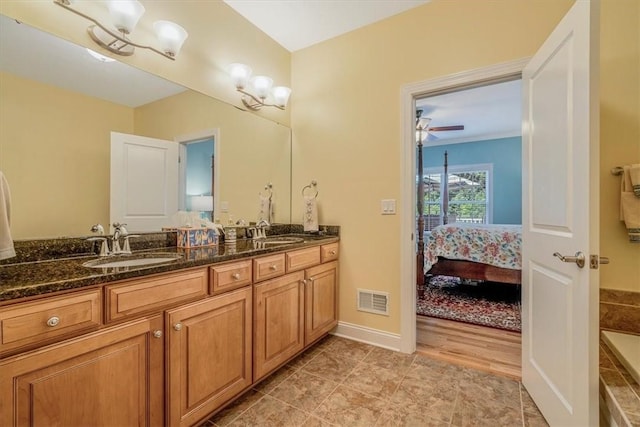1303 Shinnecock Ct, Adams Twp, PA 16046 - full bathroom with double vanity, ensuite bathroom, and a ceiling fan