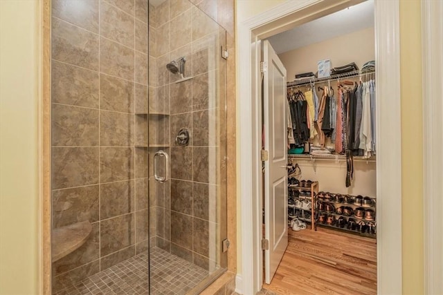 1303 Shinnecock Ct, Adams Twp, PA 16046 - bathroom with wood finished floors, a stall shower, and a spacious closet