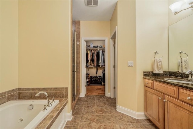 1303 Shinnecock Ct, Adams Twp, PA 16046 - full bathroom with vanity, a stall shower, a jetted tub, and a walk in closet