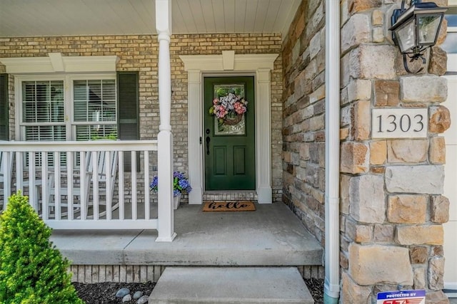1303 Shinnecock Ct, Adams Twp, PA 16046 - entrance to property with a porch, brick siding, and stone siding