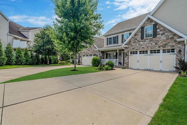 1303 Shinnecock Ct, Adams Twp, PA 16046 - craftsman house featuring stone siding, concrete driveway, a porch, and a front lawn