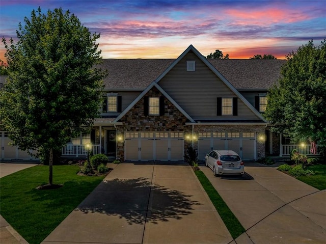 1303 Shinnecock Ct, Adams Twp, PA 16046 - craftsman-style home with concrete driveway, a lawn, stone siding, an attached garage, and a shingled roof
