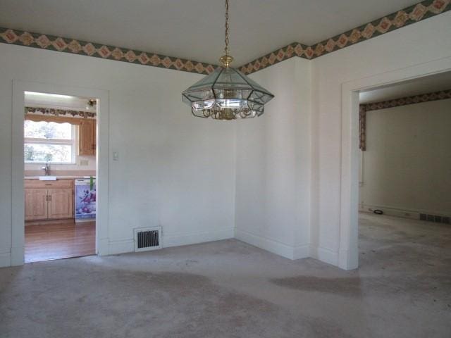 1019 Franklin St, Mckeesport, PA 15132 - spare room featuring a chandelier and carpet floors