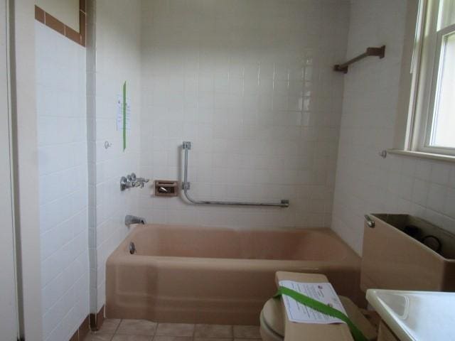 1019 Franklin St, Mckeesport, PA 15132 - bathroom with tile walls, tile patterned flooring, shower / tub combination, and vanity