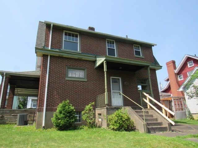 1019 Franklin St, Mckeesport, PA 15132 - view of front facade featuring brick siding and a chimney
