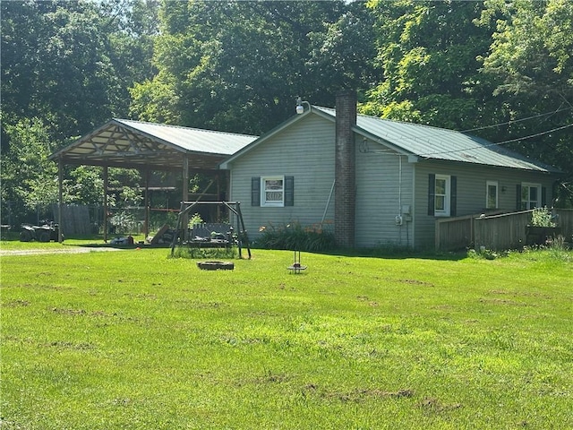 144 Barkey Hoffman, Irwin Twp, PA 16038 - view of front of house featuring a front lawn, a metal roof, a chimney, and a detached carport