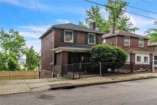 5480 Broad St, Garfield, PA 15206 - view of front facade featuring a chimney, brick siding, a gate, and a fenced front yard