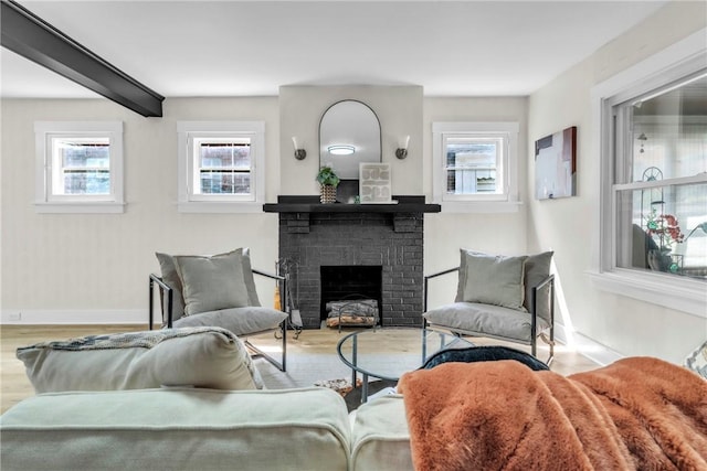 5480 Broad St, Garfield, PA 15206 - living area with plenty of natural light, a brick fireplace, and wood finished floors