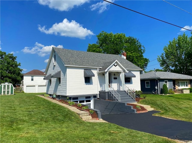 118 Delaware Ave, Scottdale, PA 15683 - bungalow with a storage shed, roof with shingles, a front yard, a garage, and a chimney