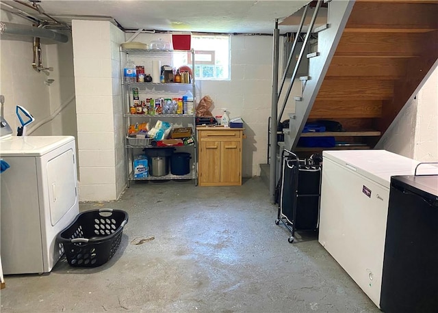 118 Delaware Ave, Scottdale, PA 15683 - basement featuring washer and dryer, fridge, concrete block wall, and stairway
