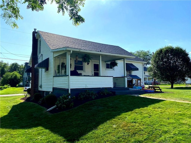 118 Delaware Ave, Scottdale, PA 15683 - view of front of house with a front yard, a porch, a chimney, and roof with shingles