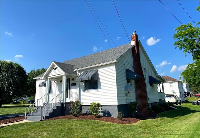 118 Delaware Ave, Scottdale, PA 15683 - bungalow-style home with a front lawn, a shingled roof, and a chimney