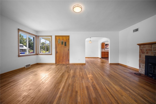 389 Mercer Rd, Hempfield Twp Mer, PA 16125 - unfurnished living room featuring hardwood / wood-style floors, arched walkways, and a fireplace