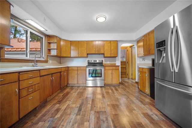 389 Mercer Rd, Hempfield Twp Mer, PA 16125 - kitchen with stainless steel appliances, brown cabinetry, hardwood / wood-style floors, and light countertops