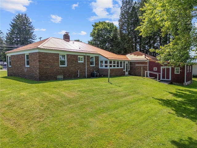 389 Mercer Rd, Hempfield Twp Mer, PA 16125 - rear view of property with a chimney, a lawn, brick siding, and a metal roof