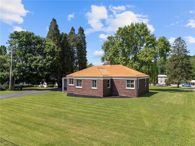389 Mercer Rd, Hempfield Twp Mer, PA 16125 - view of side of property with a lawn, a chimney, brick siding, and asphalt driveway