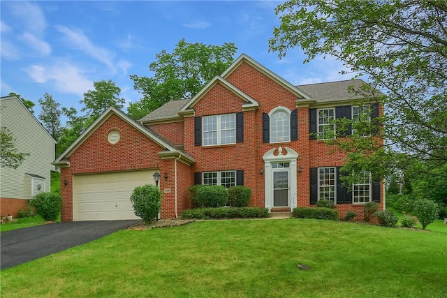 216 Beagle Dr, Moon/Crescent Twp, PA 15108 - colonial house with a garage, asphalt driveway, a front lawn, and brick siding
