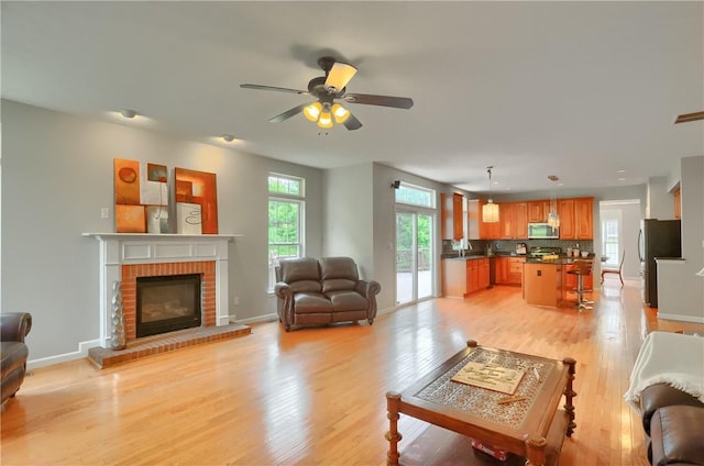 216 Beagle Dr, Moon/Crescent Twp, PA 15108 - living room with healthy amount of natural light, light wood-style floors, and a fireplace