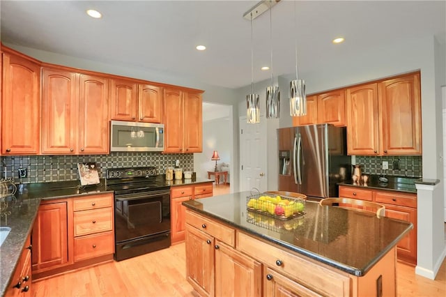 216 Beagle Dr, Moon/Crescent Twp, PA 15108 - kitchen featuring stainless steel appliances, backsplash, light wood-style flooring, a kitchen island, and dark stone counters