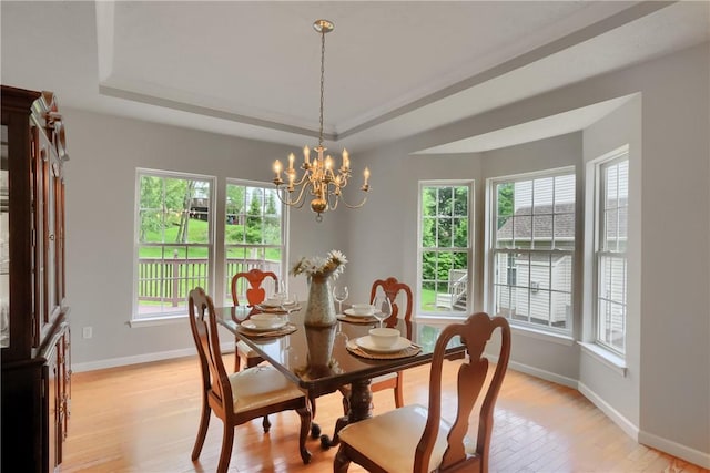 216 Beagle Dr, Moon/Crescent Twp, PA 15108 - dining space featuring a raised ceiling, a chandelier, and light wood-style flooring