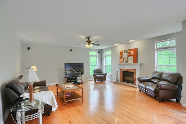 216 Beagle Dr, Moon/Crescent Twp, PA 15108 - living room featuring wood finished floors, a ceiling fan, and a fireplace