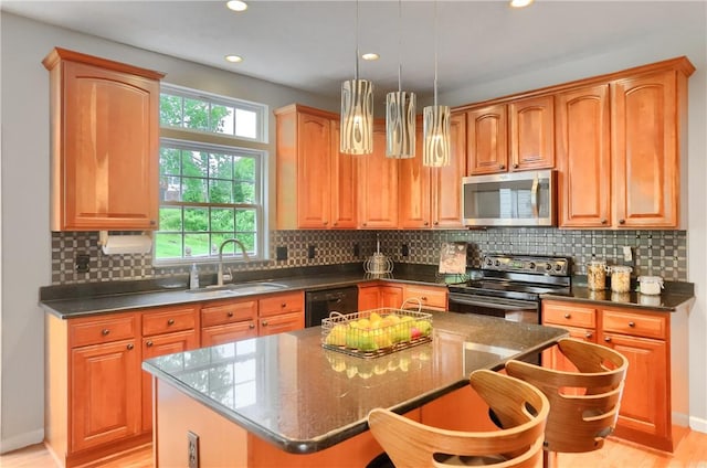 216 Beagle Dr, Moon/Crescent Twp, PA 15108 - kitchen featuring stainless steel appliances, light wood-style flooring, a kitchen island, hanging light fixtures, and recessed lighting