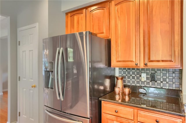 216 Beagle Dr, Moon/Crescent Twp, PA 15108 - kitchen with stainless steel refrigerator with ice dispenser, tasteful backsplash, dark stone counters, and brown cabinetry