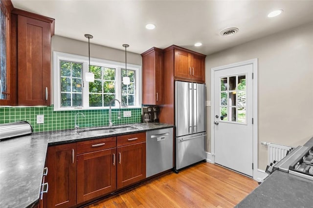 234 Orchard Dr, Mt Lebanon, PA 15228 - kitchen with appliances with stainless steel finishes, light wood-style flooring, backsplash, plenty of natural light, and recessed lighting