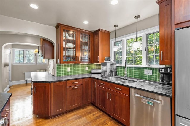 234 Orchard Dr, Mt Lebanon, PA 15228 - kitchen featuring appliances with stainless steel finishes, arched walkways, decorative backsplash, decorative light fixtures, and recessed lighting
