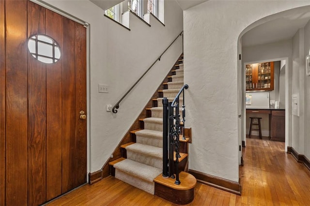 234 Orchard Dr, Mt Lebanon, PA 15228 - foyer featuring arched walkways, hardwood / wood-style flooring, and stairs