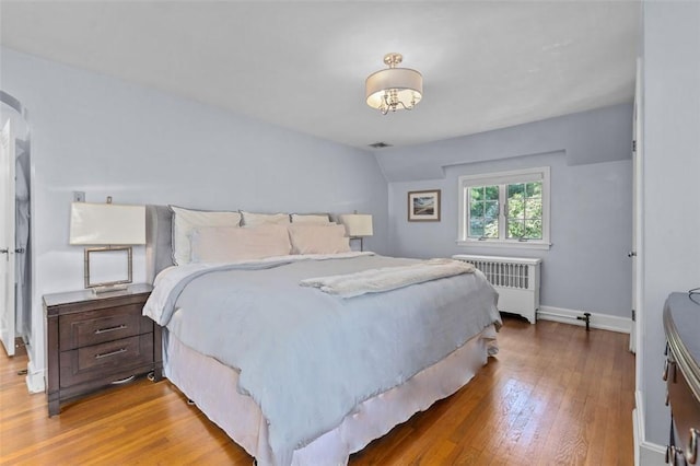 234 Orchard Dr, Mt Lebanon, PA 15228 - bedroom with radiator heating unit, wood finished floors, lofted ceiling, and arched walkways
