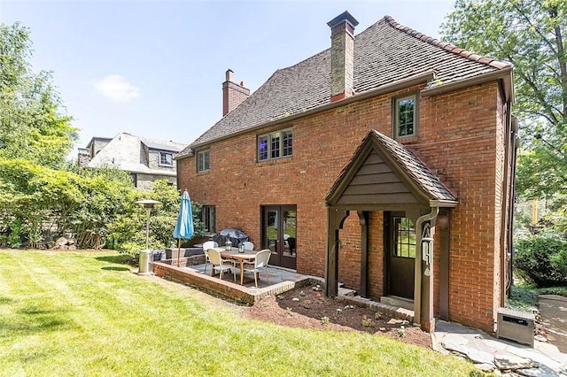 234 Orchard Dr, Mt Lebanon, PA 15228 - rear view of property with a chimney, brick siding, a yard, a patio, and french doors