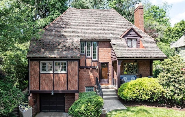 234 Orchard Dr, Mt Lebanon, PA 15228 - tudor home featuring a chimney, brick siding, and a garage