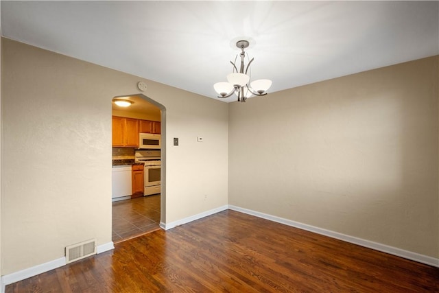 108 Bellanca Ave, Brentwood, PA 15227 - spare room with arched walkways, a chandelier, dark wood finished floors, and a smoke detector